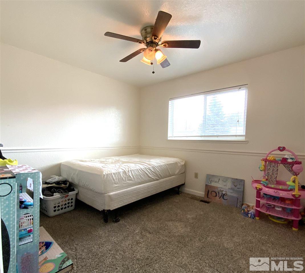 282 River Boat Road Dayton, NV 89403 - Photo 13 of 15 a bedroom with a bed and a chandelier