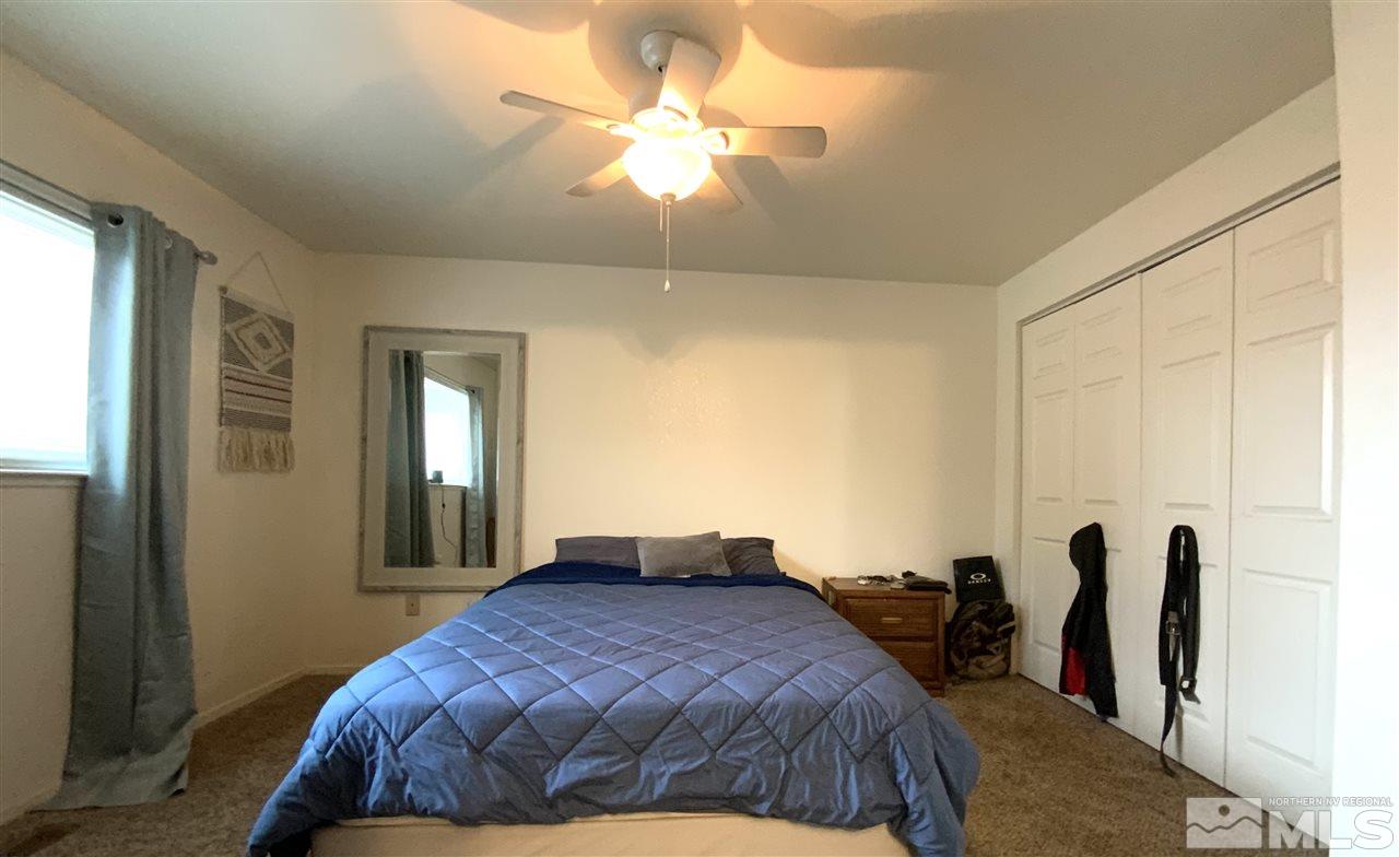 282 River Boat Road Dayton, NV 89403 - Photo 14 of 15 a bedroom with a bed and a chandelier