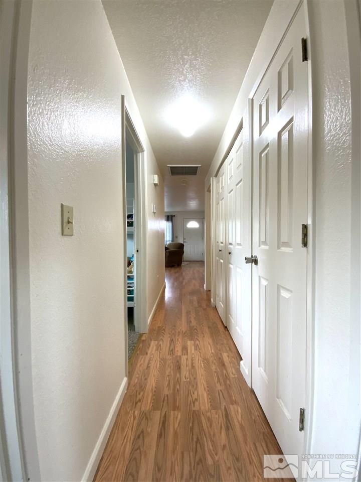 282 River Boat Road Dayton, NV 89403 - Photo 6 of 15 a view of a hallway with wooden floor