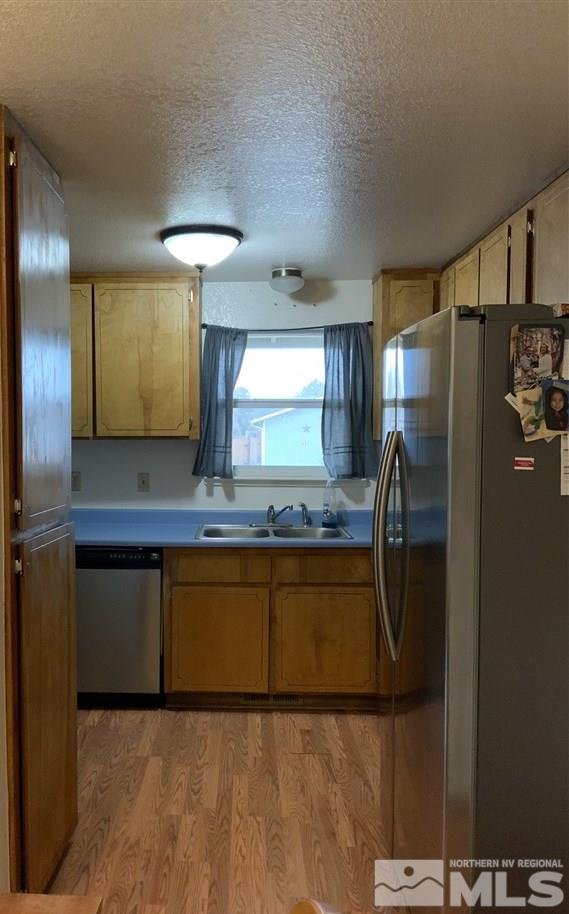 282 River Boat Road Dayton, NV 89403 - Photo 8 of 15 a kitchen with stainless steel appliances granite countertop a refrigerator and a sink