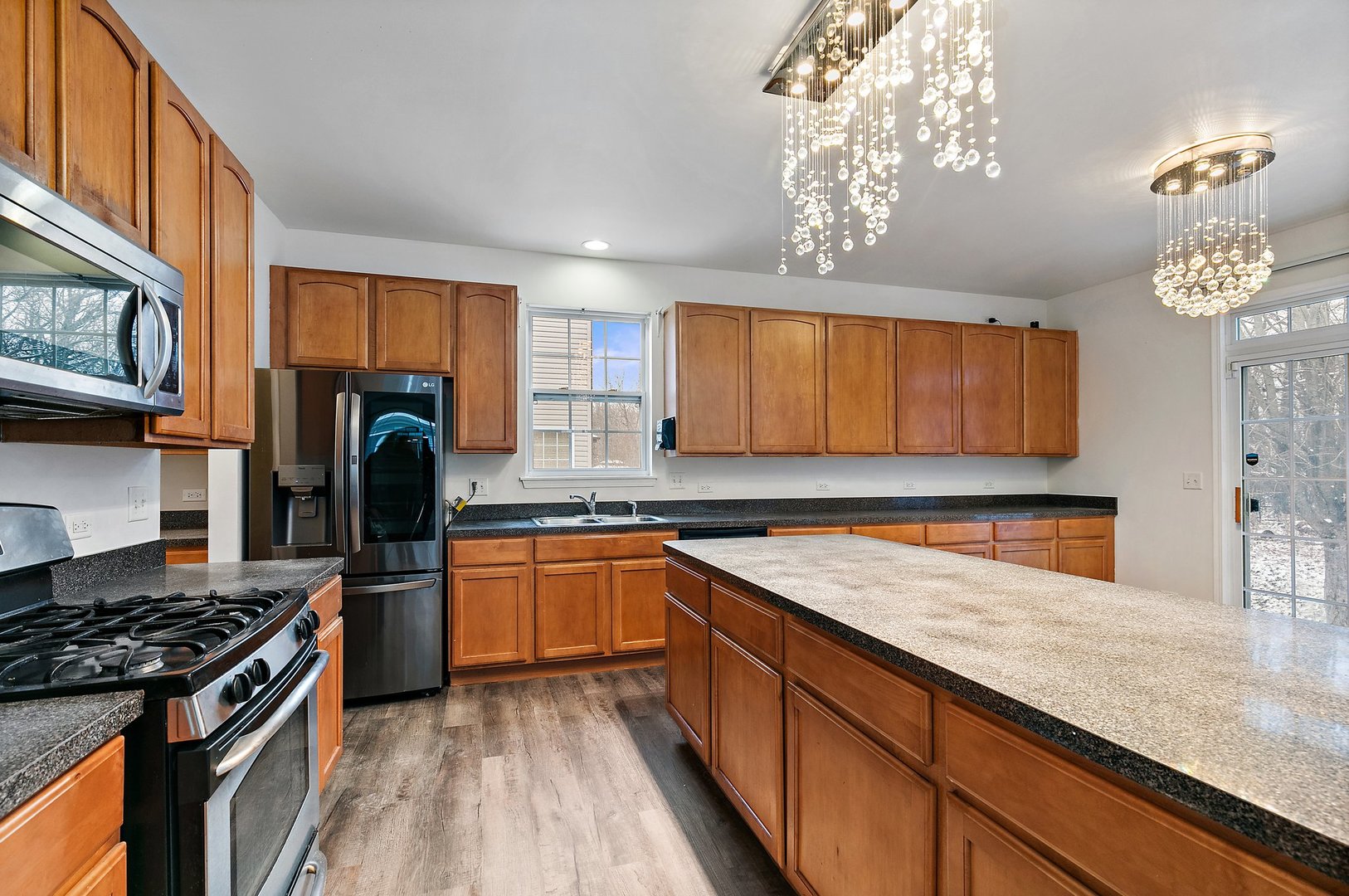 5734 Red Oak Drive Hoffman Estates, IL 60192 - Photo 11 of 31 a kitchen with stainless steel appliances granite countertop a sink stove and refrigerator