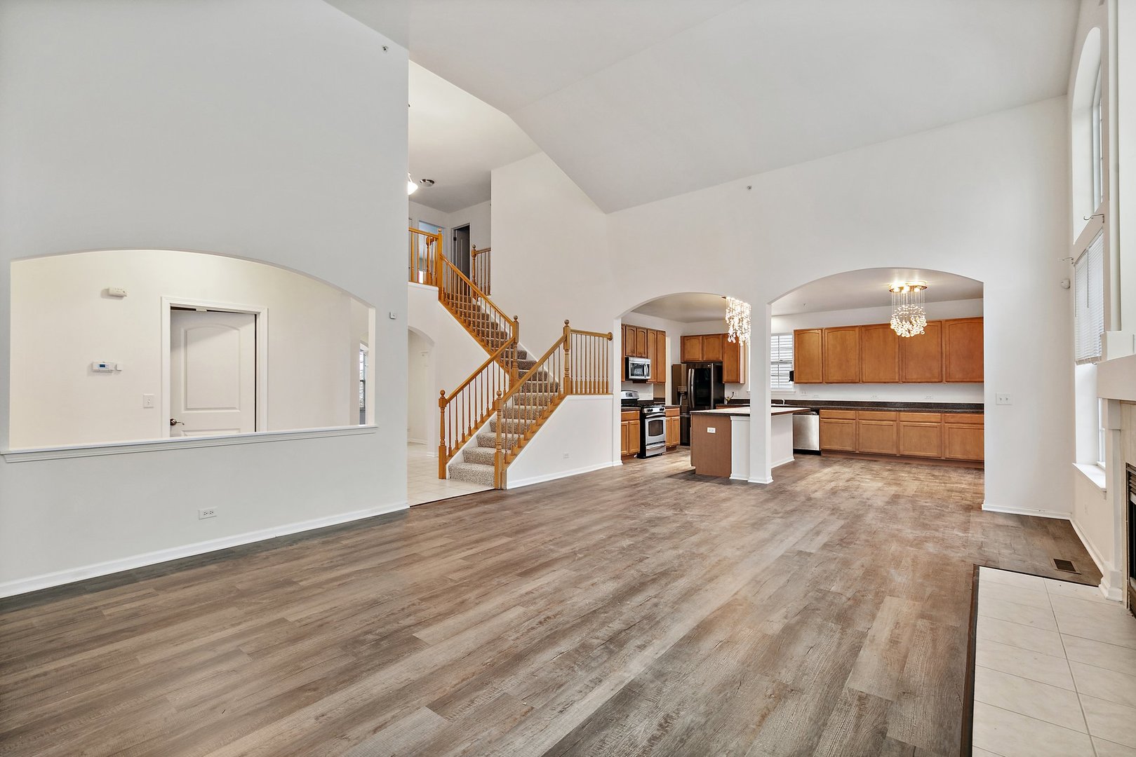 5734 Red Oak Drive Hoffman Estates, IL 60192 - Photo 13 of 31 a view of a livingroom with wooden floor and stairs