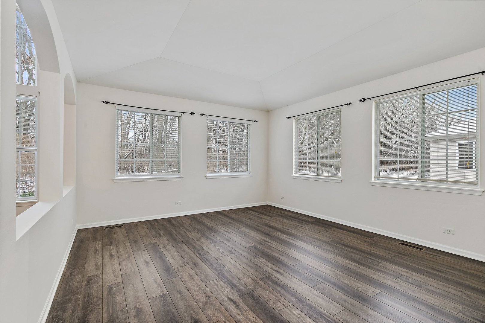 5734 Red Oak Drive Hoffman Estates, IL 60192 - Photo 16 of 31 a view of an empty room with wooden floor and a window