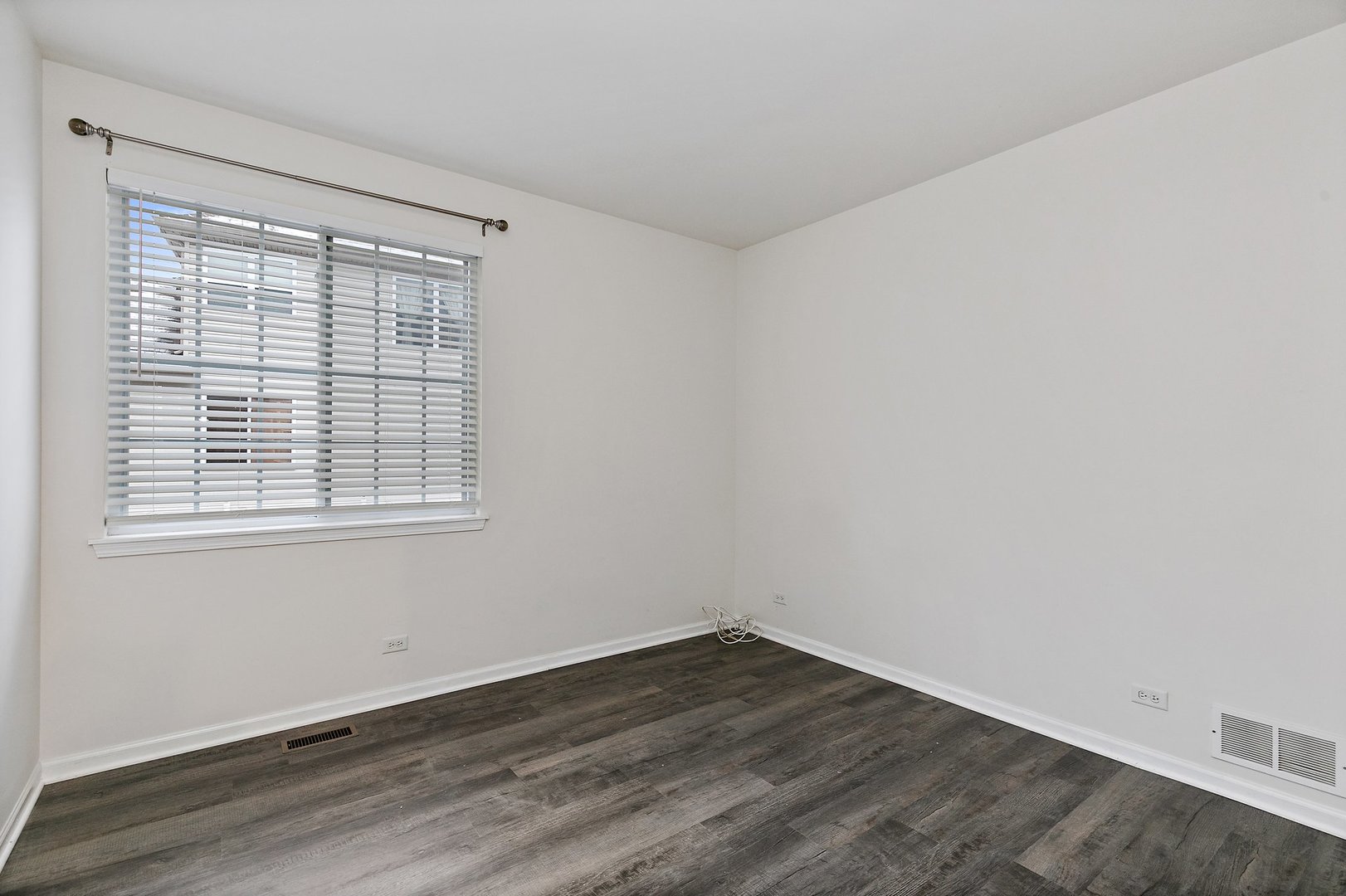 5734 Red Oak Drive Hoffman Estates, IL 60192 - Photo 17 of 31 wooden floor in an empty room with a window