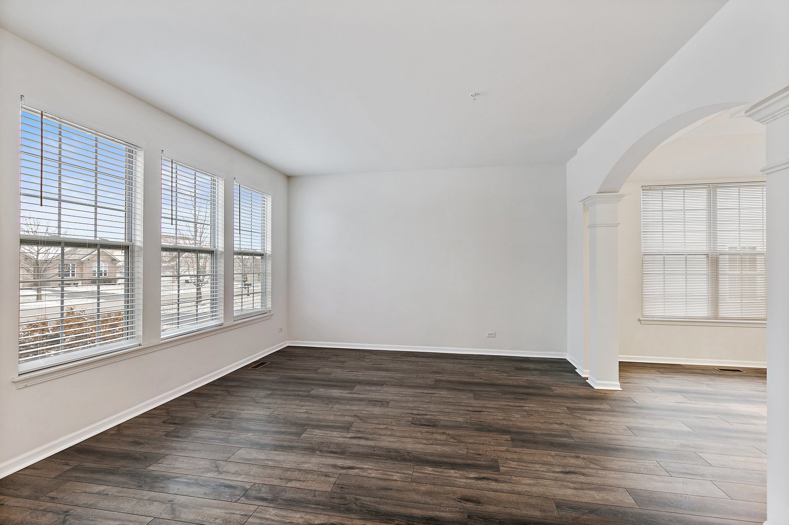 5734 Red Oak Drive Hoffman Estates, IL 60192 - Photo 5 of 31 a view of an empty room with wooden floor and a window