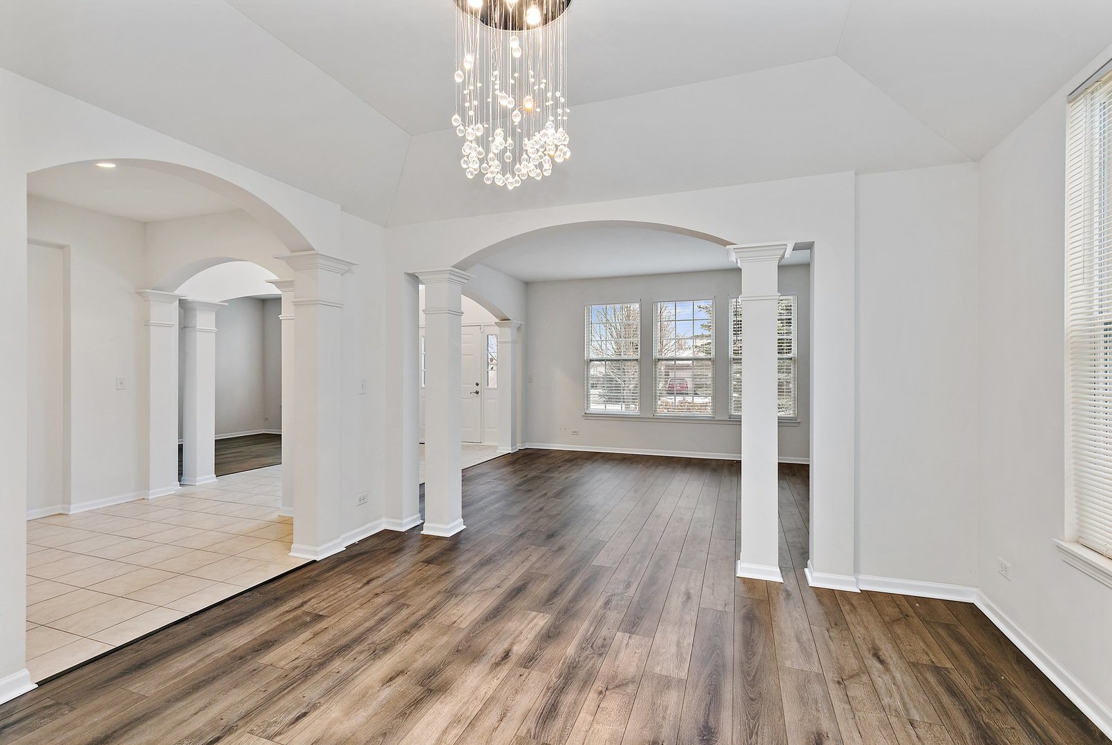 5734 Red Oak Drive Hoffman Estates, IL 60192 - Photo 7 of 31 wooden floor in an empty room with a window