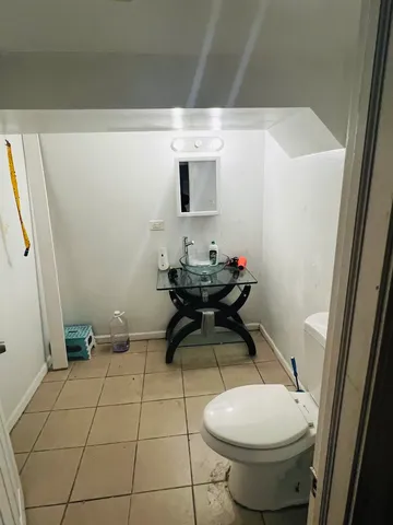 a bathroom with a sink toilet and a mirror