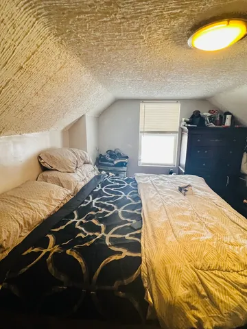 a bedroom with a bed and window