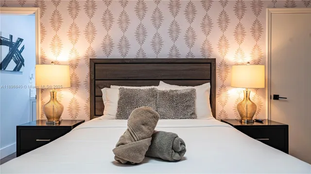 a bedroom with a bed and a night stand