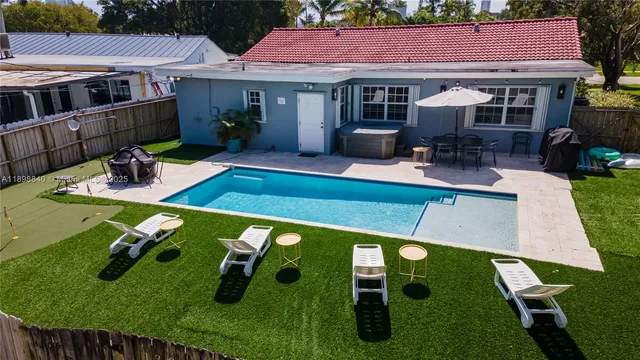 a view of an house with backyard space and sitting area