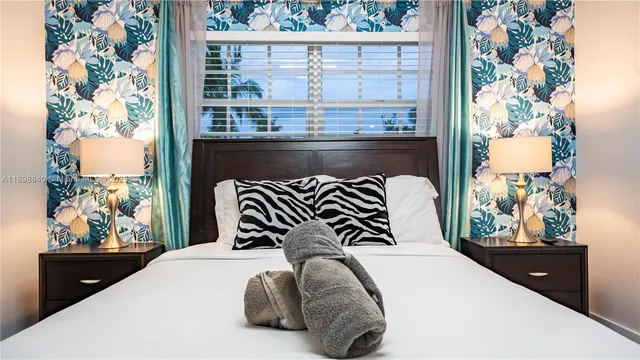 a bedroom with a bed and a potted plant