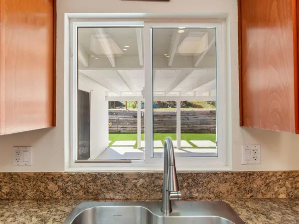 a kitchen with stainless steel appliances granite countertop a sink stove and cabinets