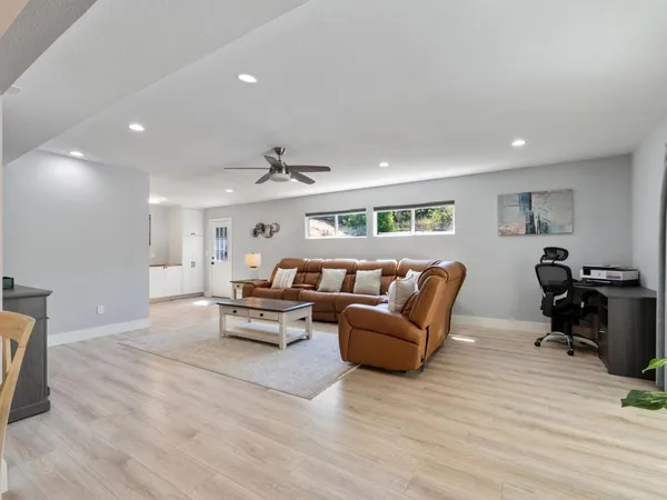 a living room with furniture and wooden floor
