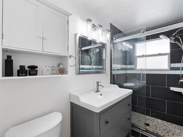 a bathroom with a sink toilet and shower