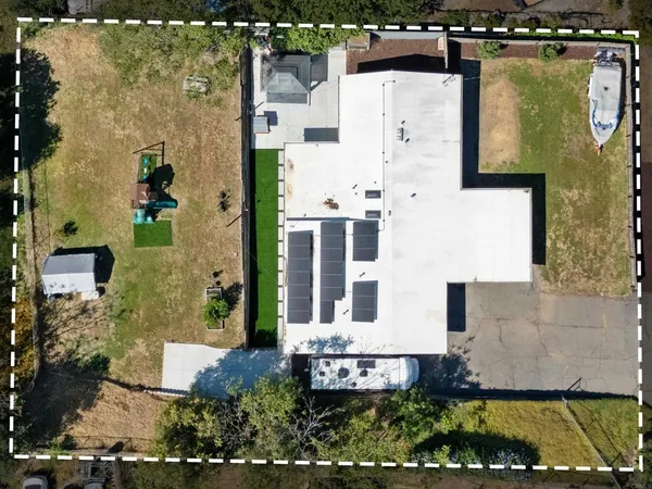 an aerial view of a house with a yard