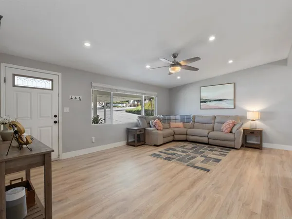 a living room with furniture and wooden floor