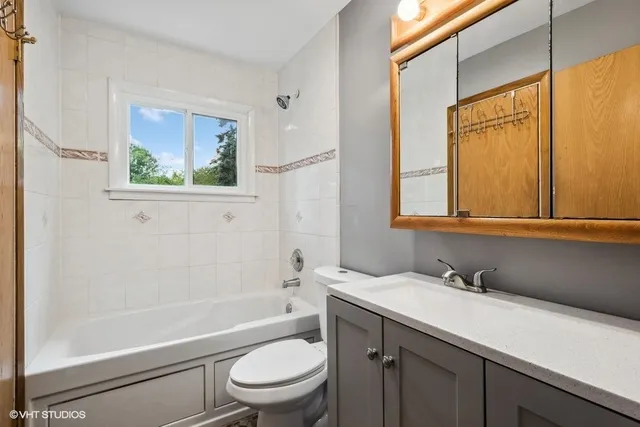 a bathroom with a granite countertop sink toilet a mirror and shower