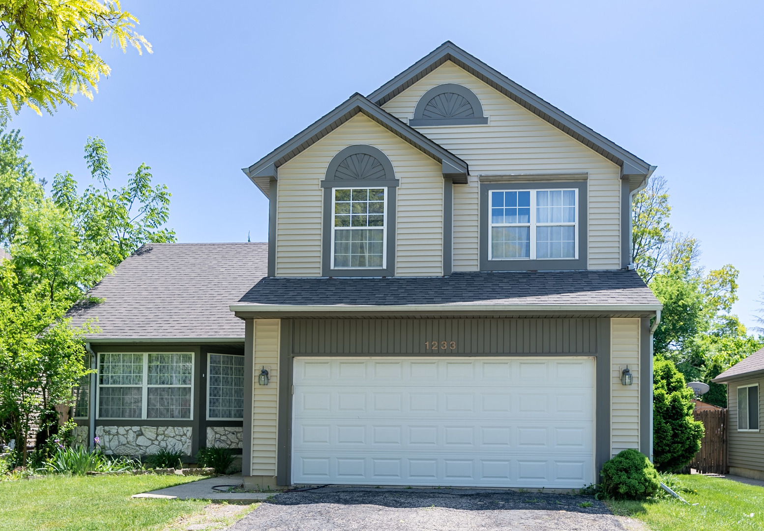 1233 Concord Drive Elgin, IL 60120 - Photo 1 of 28 a front view of a house with garden