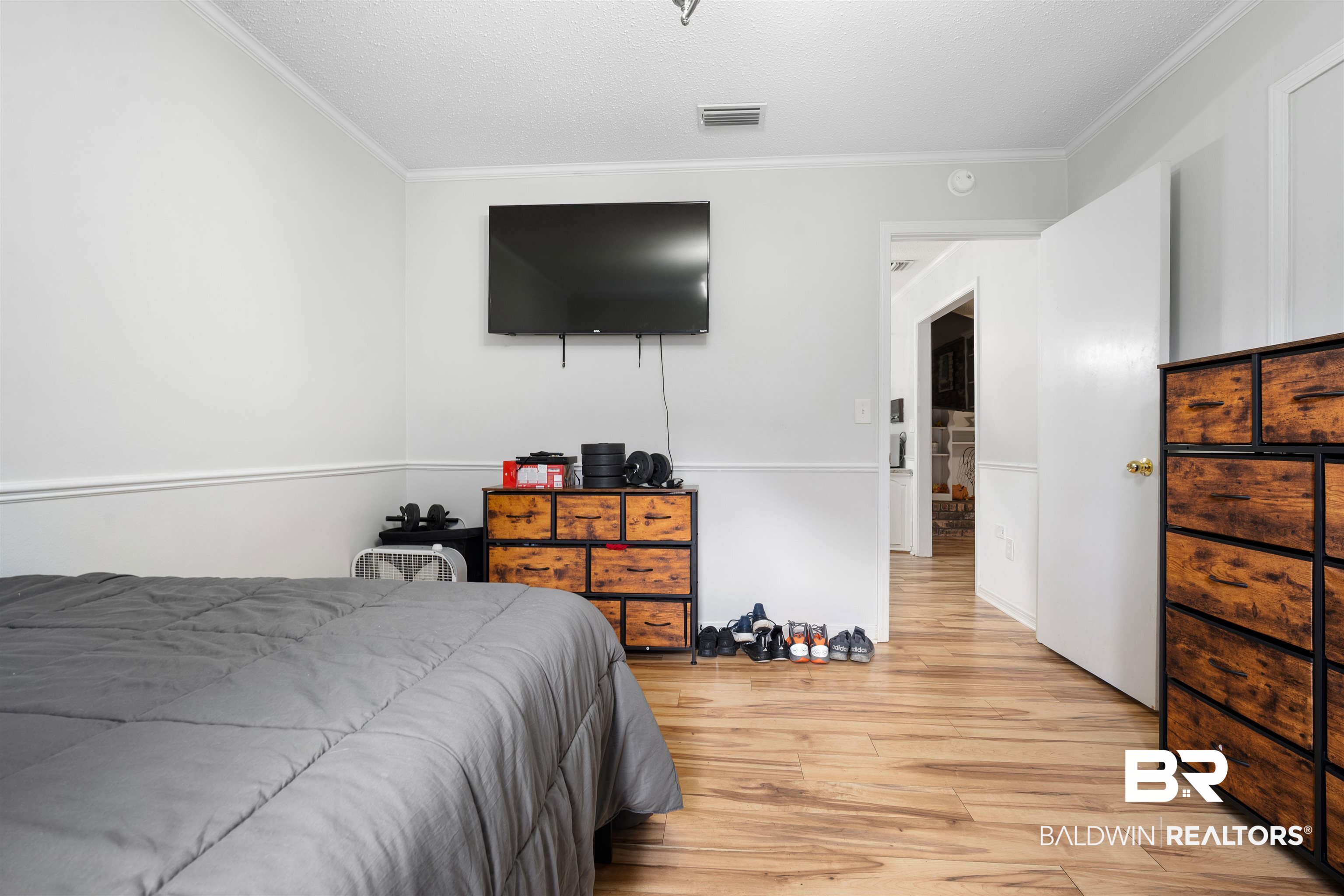 7807 Yorkhaven Road Mobile, AL 36695 - Photo 24 of 34 Bedroom featuring crown molding, wood finished floors, and a textured ceiling