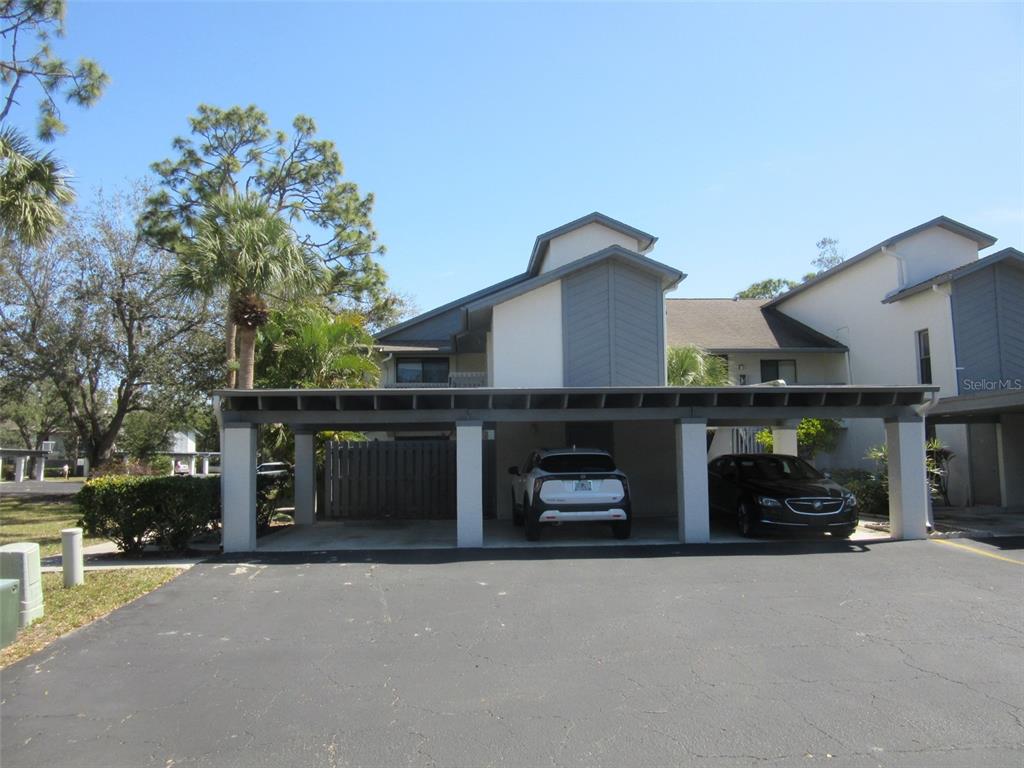 17455 Overhill Drive, Unit B Fort Myers, FL 33908 - Photo 1 of 13 a front view of a house with a yard and parking