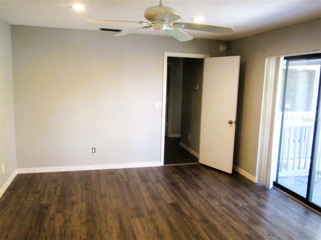 17455 Overhill Drive, Unit B Fort Myers, FL 33908 - Photo 11 of 13 a view of an empty room with wooden floor and a window