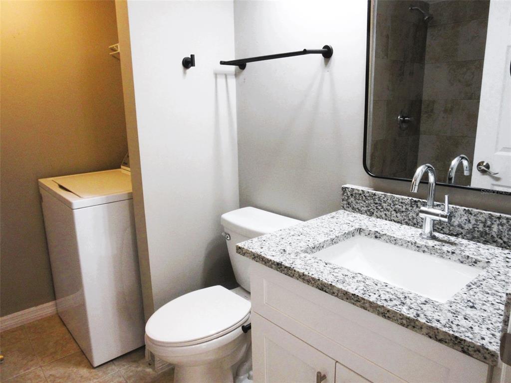 17455 Overhill Drive, Unit B Fort Myers, FL 33908 - Photo 12 of 13 a bathroom with a granite countertop sink toilet and shower