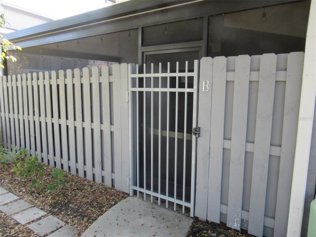 17455 Overhill Drive, Unit B Fort Myers, FL 33908 - Photo 2 of 13 a view of a house with a wooden fence