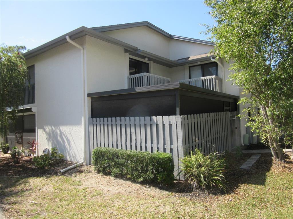 17455 Overhill Drive, Unit B Fort Myers, FL 33908 - Photo 3 of 13 a view of a house with a small yard and plants