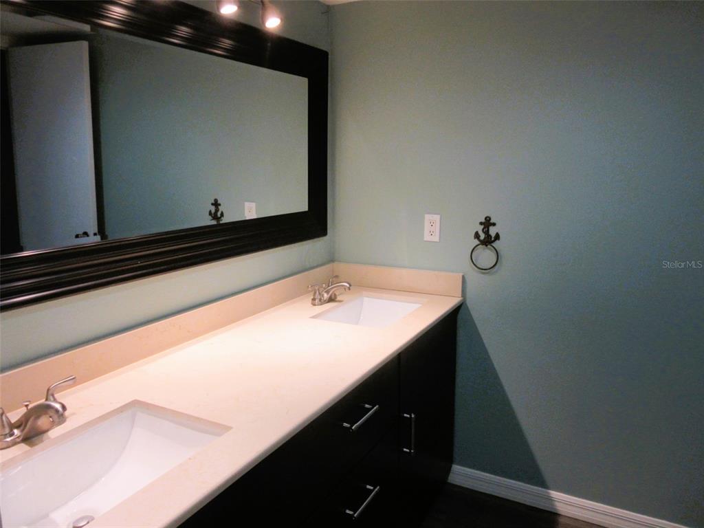 17455 Overhill Drive, Unit B Fort Myers, FL 33908 - Photo 9 of 13 a bathroom with a sink and mirror