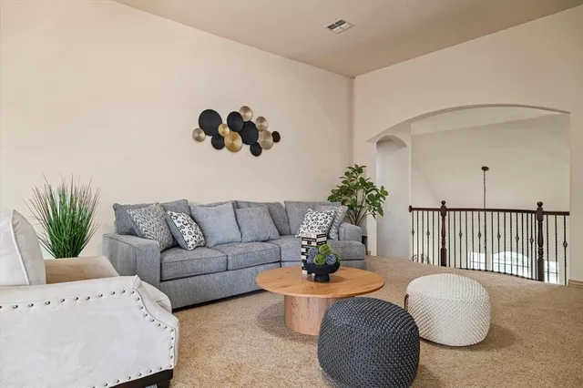 a living room with furniture and flowers