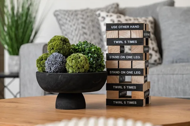 a table with a potted plant and a wooden floor