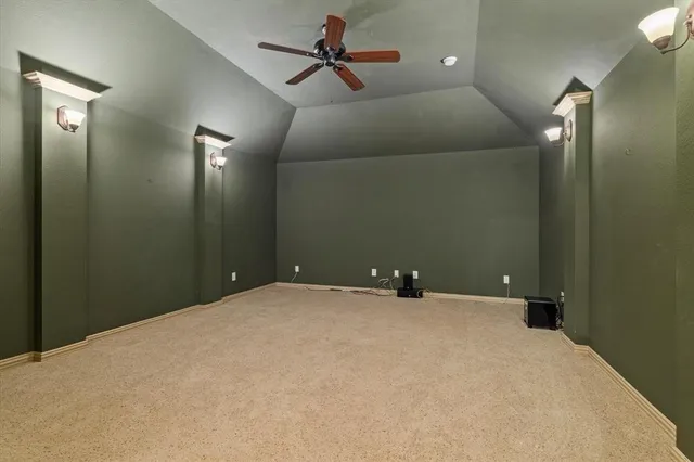 a view of a room with a ceiling fan