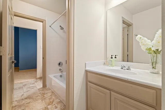 a bathroom with a sink a mirror and a shower