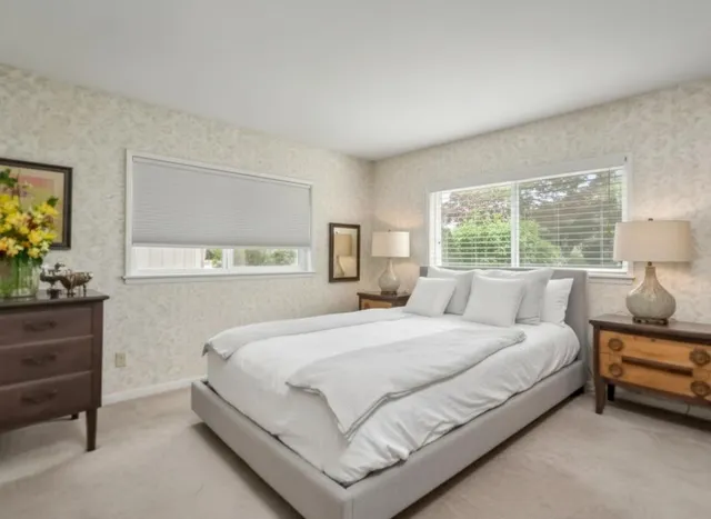 a bedroom with a bed window and a dresser