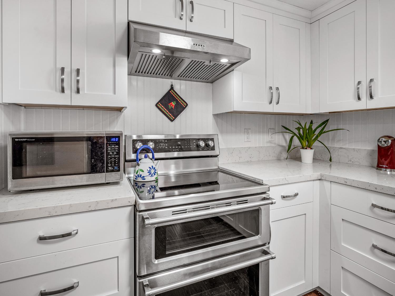 2850 Hidden Springs Circle Placerville, CA 95667 - Photo 15 of 40 a kitchen with white cabinets stainless steel appliances and wooden floor