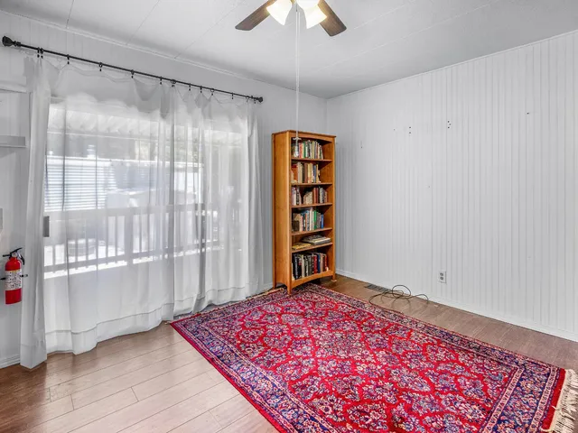 a bedroom with a bed and a chandelier fan