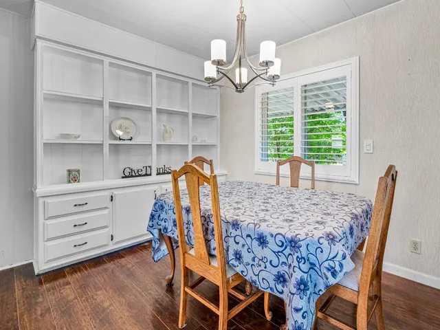 a view of a dining room with furniture and chandelier