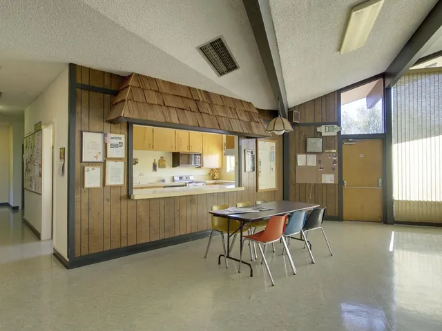 a dining room with furniture and window