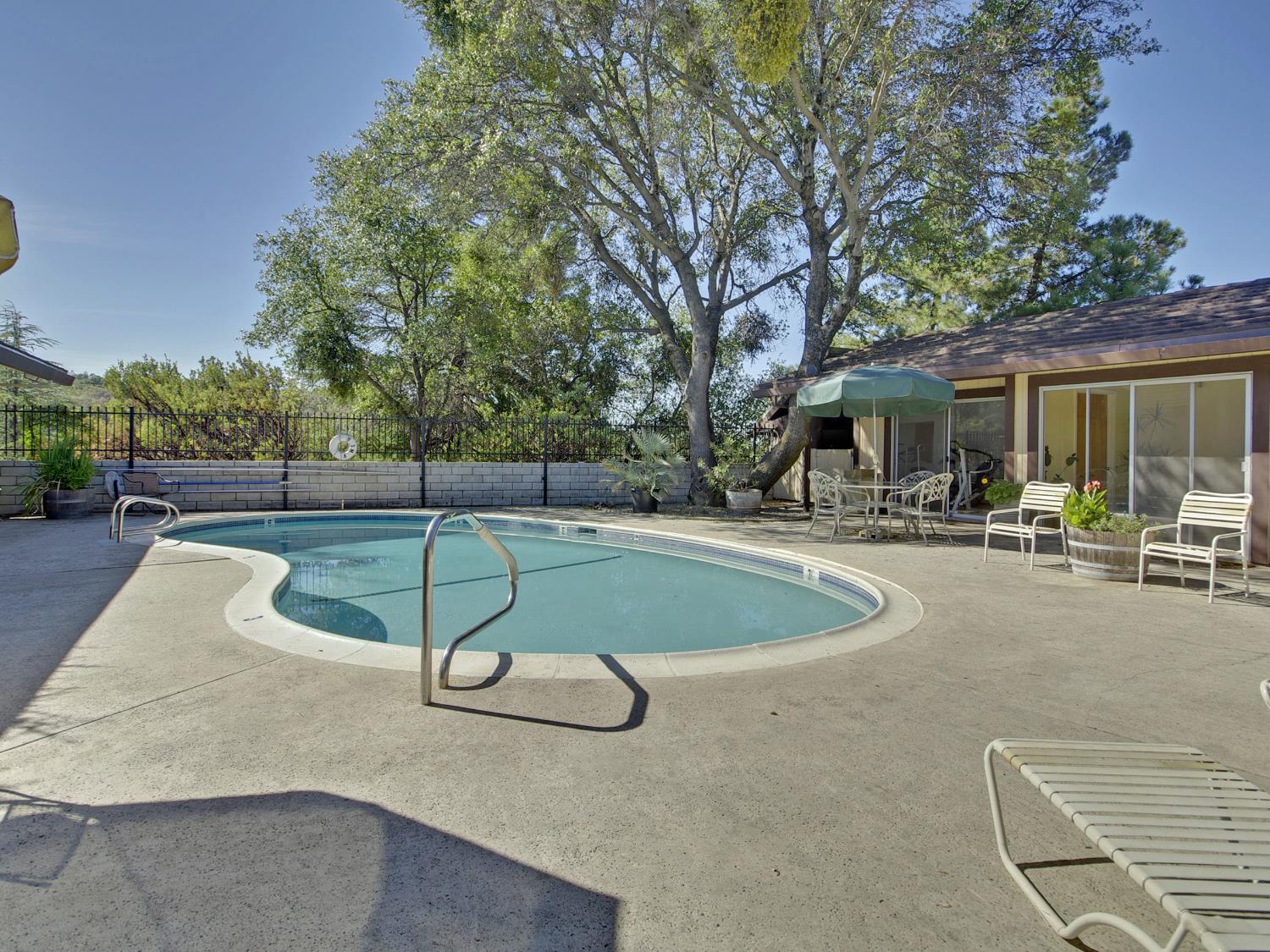 2850 Hidden Springs Circle Placerville, CA 95667 - Photo 38 of 40 a swimming pool with outdoor seating and yard