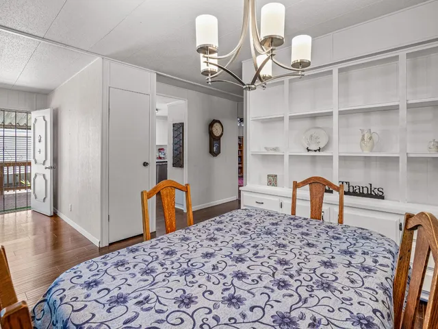 a bedroom with bed and wooden floor