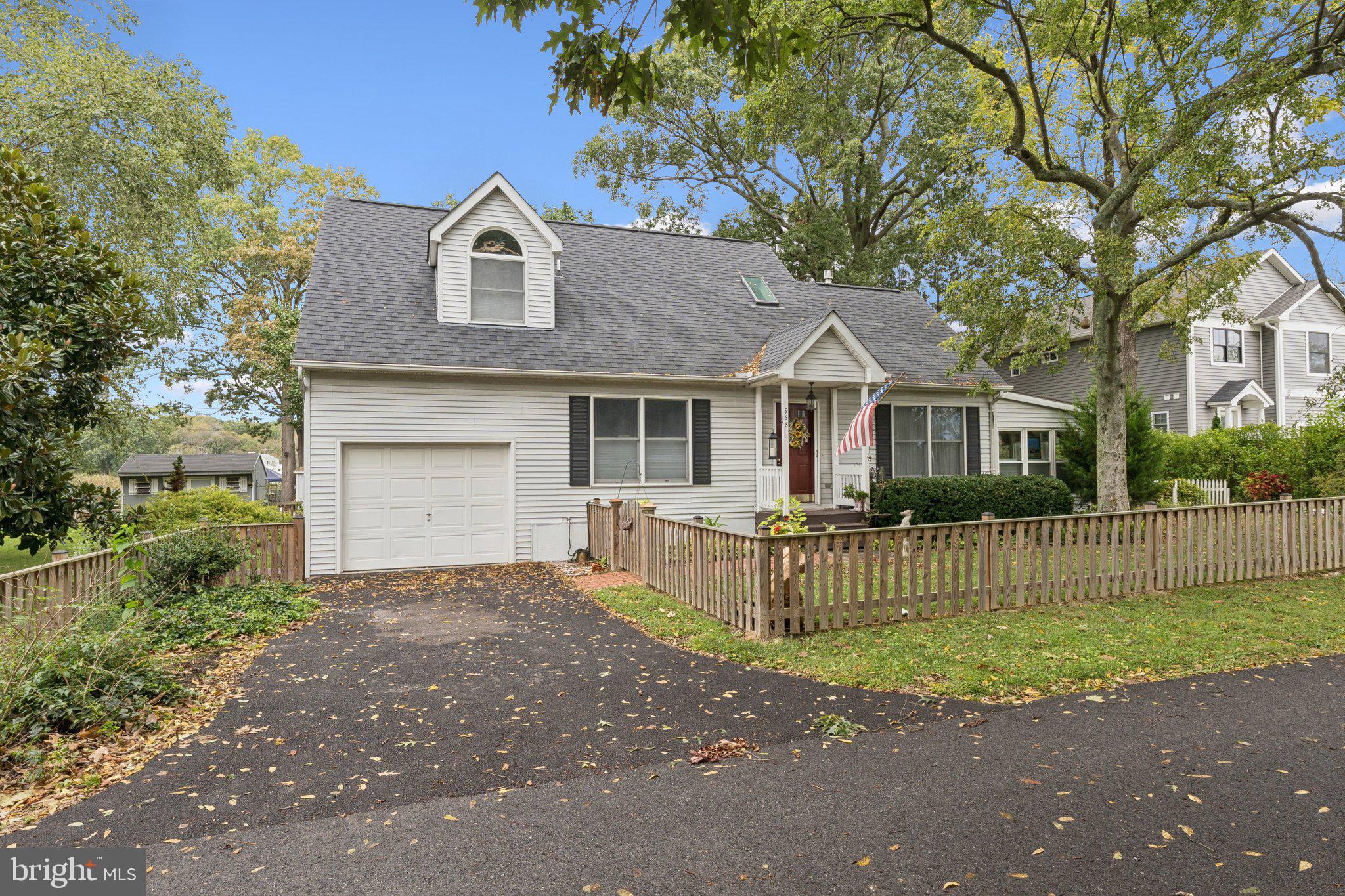 968 Chesapeake Avenue Deale, MD 20751 - Photo 1 of 57 a front view of a house with a garden