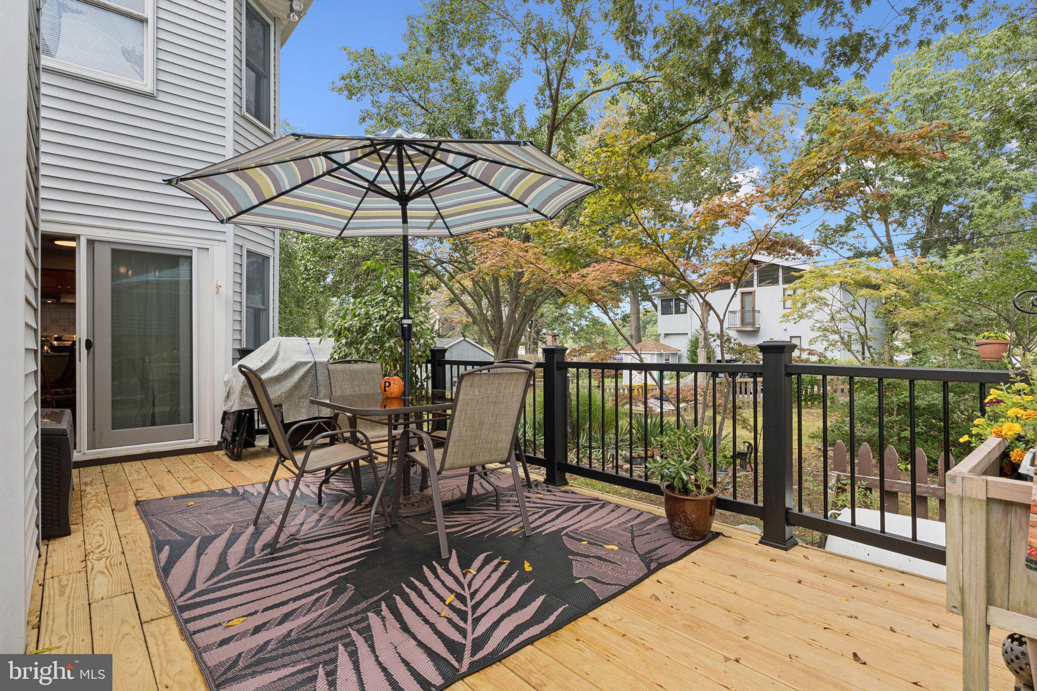968 Chesapeake Avenue Deale, MD 20751 - Photo 29 of 57 a view of a patio with wooden floor table and chairs