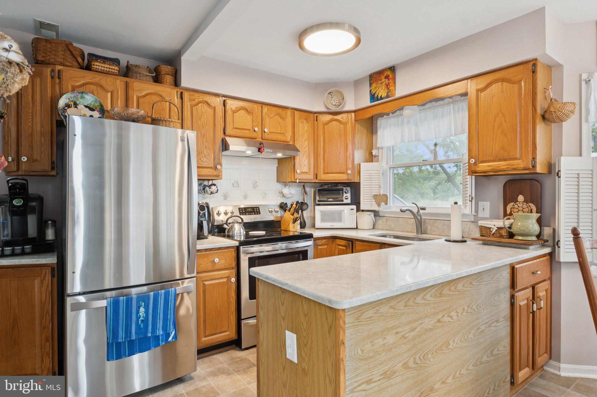 968 Chesapeake Avenue Deale, MD 20751 - Photo 9 of 57 a kitchen with stainless steel appliances granite countertop a refrigerator a sink dishwasher a stove and a refrigerator