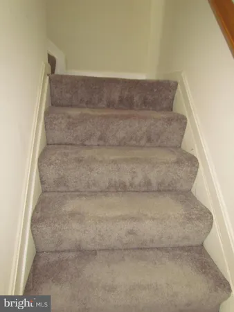 a view of staircase with white walls