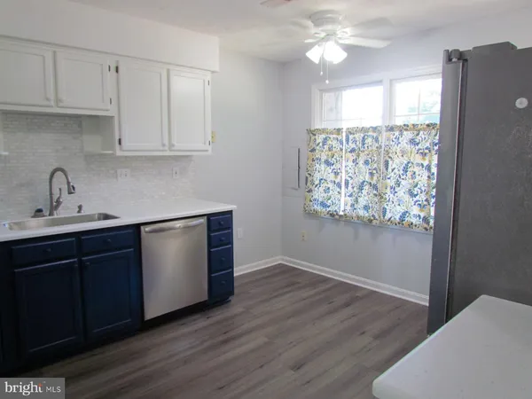 a kitchen with wooden cabinets and sink