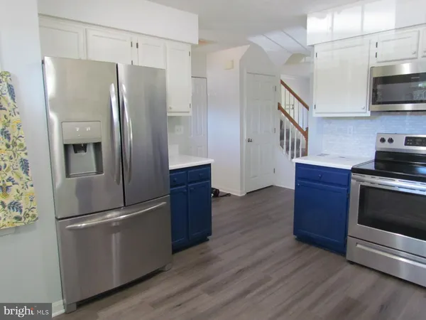 a kitchen with stainless steel appliances a refrigerator and a stove top oven