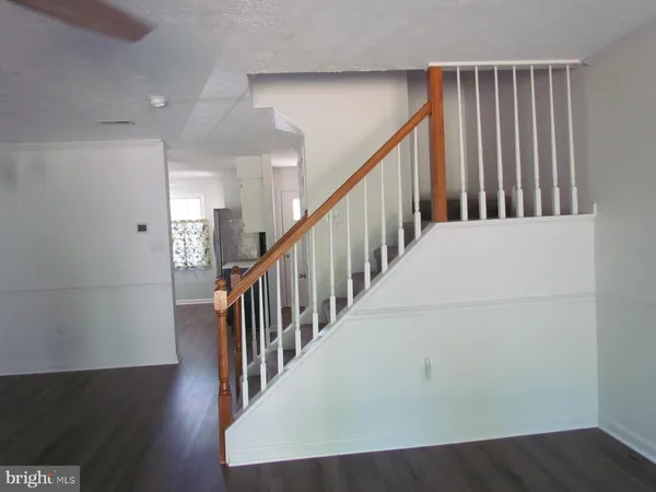 a view of a hallway with wooden floor and entryway