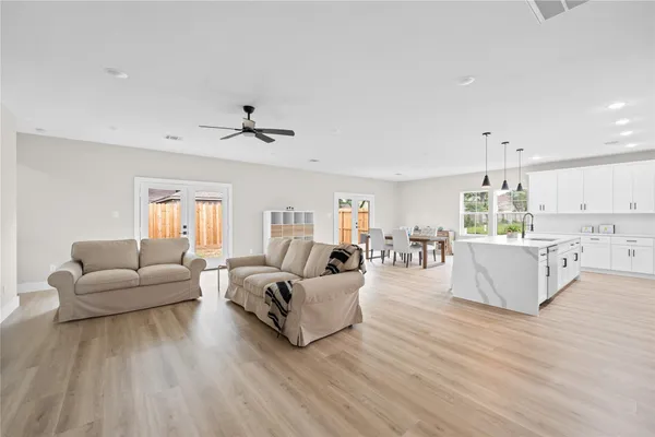 a living room with furniture and wooden floor