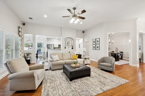 a living room with furniture ceiling fan and a rug