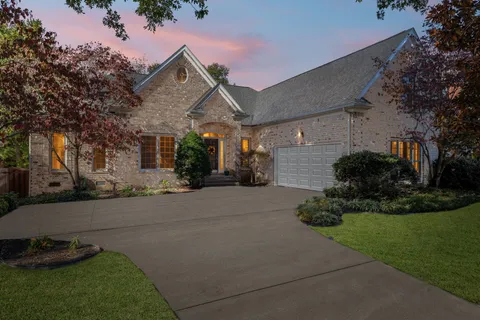 a front view of a house with a yard and a garage